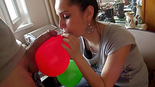 Adorable brunette licking sperm from balloon